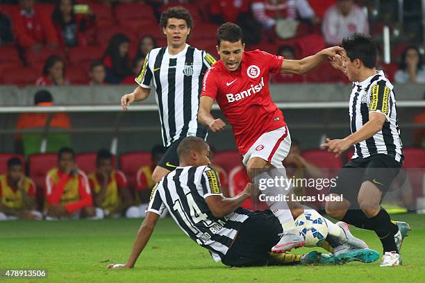 Nilmar of Internacional battles for the ball against David Braz of Santos during the match between Internacional and Santos as part of Brasileirao...