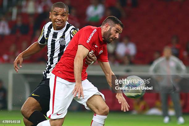Lisandro Lopez of Internacional battles for the ball against David Braz of Santos during the match between Internacional and Santos as part of...