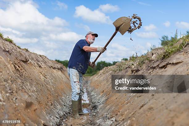 old man digging a ditch - ditch stock pictures, royalty-free photos & images