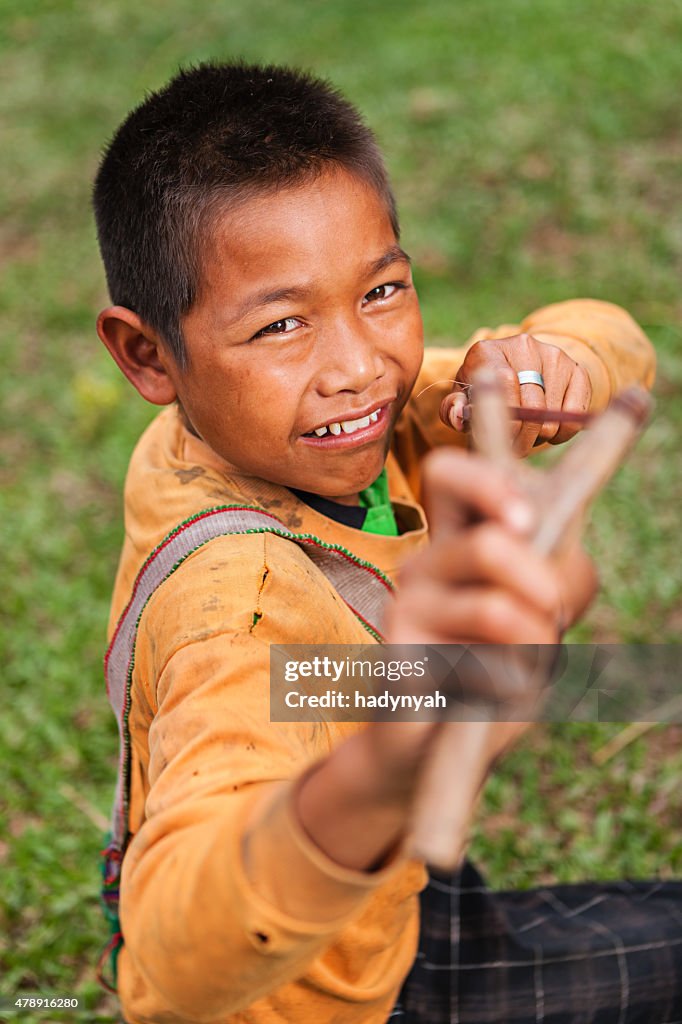 Young boy with slinghshoot in Northern Laos