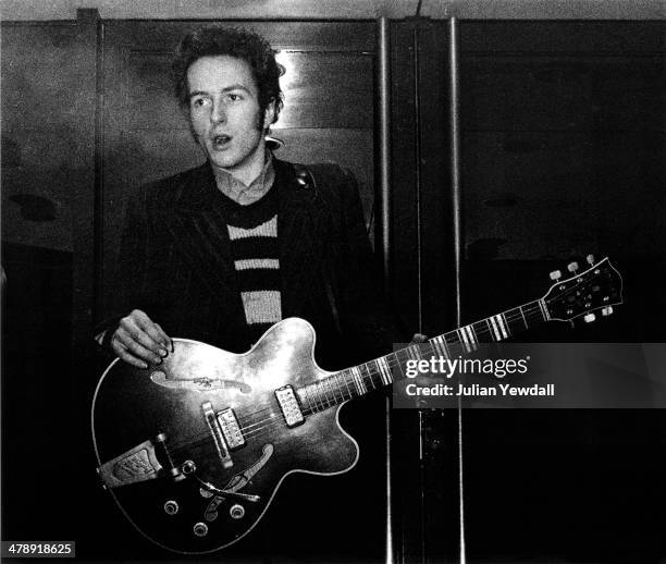 Joe Strummer of English pub rock group The 101ers, in the doorway of The Colonnades Porchester Square, London, 1976. Strummer joined The Clash later...