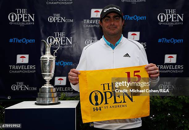 Steven Bowditch of Australia holds a hole flag and stands next to the Open Championship Trophy after qualifying for the Open Championship during the...