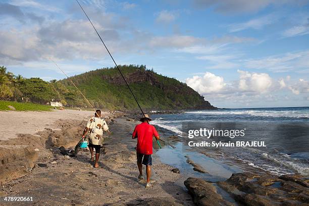 Fishermen in the beach of Grand Anse, petite ile, South coast of Reunion Island, Indian Ocean, France.