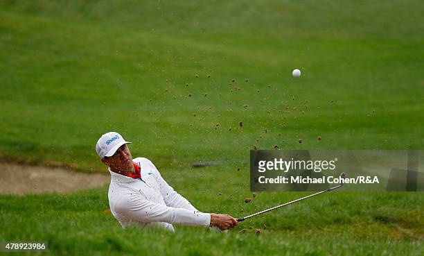 Graham Delaet of Canada hits his second shot on the fifth hole from a bunker during the final round of the Travelers Championship held at TPC River...