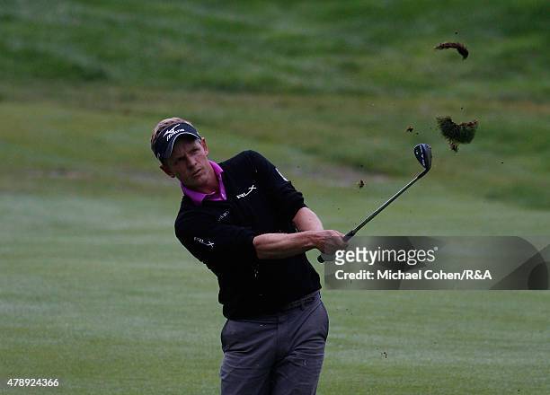Luke Donald of England hits his third shot on the 18th hole during the final round of the Travelers Championship held at TPC River Highlands on June...