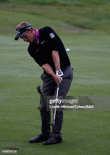 Luke Donald of England hits his third shot on the 18th hole during the final round of the Travelers Championship held at TPC River Highlands on June...