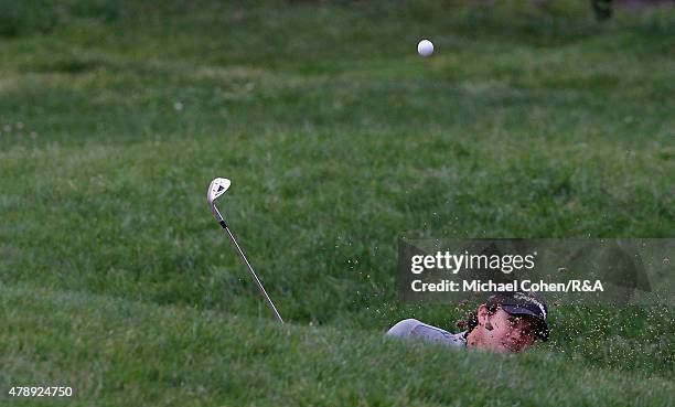 Brian Harman of the United States hits his second shot on the eighth hole from a bunkerduring the final round of the Travelers Championship held at...