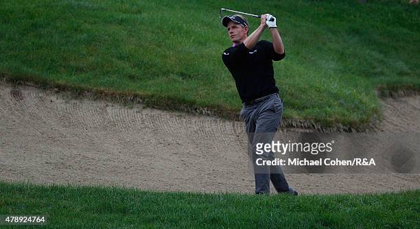 Luke Donald of England hits his second shot on the 18th hole during the final round of the Travelers Championship held at TPC River Highlands on June...