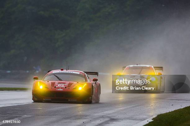 The Ferrari of Pierre Kaffer and Giancarlo Fisichella races in the rain during the Sahlen's Six Hours of the Glen at Watkins Glen International on...