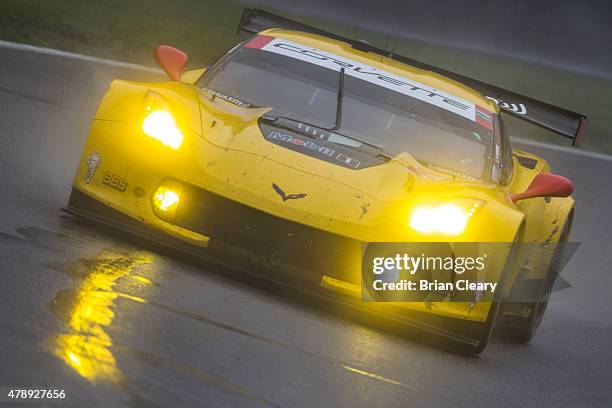 The Corvette of Jan Magnussen and Antonio Garcia races in the rain during the Sahlen's Six Hours of the Glen at Watkins Glen International on June...