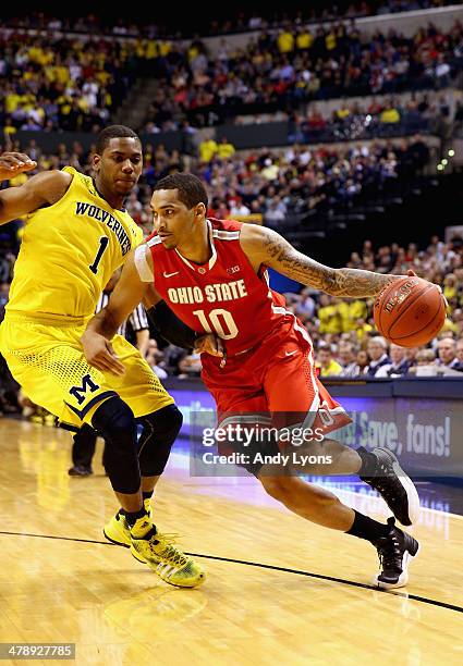 LaQuinton Ross of the Ohio State Buckeyes drives the ball past Glenn Robinson III of the Michigan Wolverines during the second half of the Big Ten...