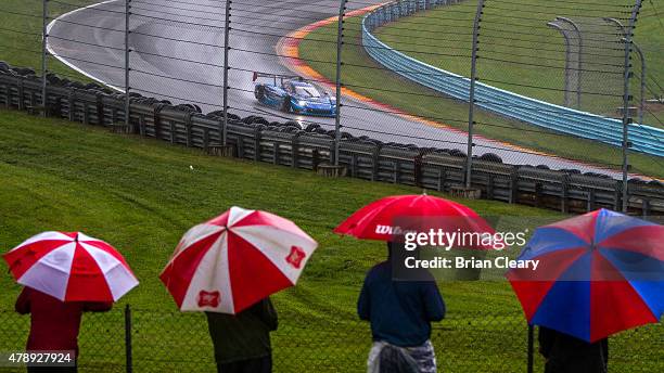 Group of fans watches the action in the rain during the Sahlen's Six Hours of the Glen at Watkins Glen International on June 28, 2015 in Watkins...