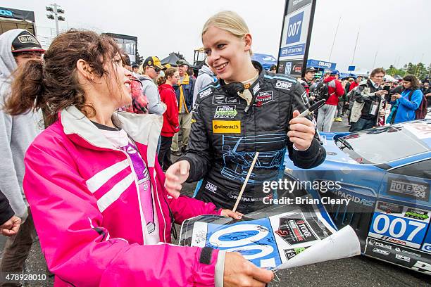 Christina Nielsen signs an autograph during the fan walk before the Sahlen's Six Hours of the Glen at Watkins Glen International on June 28, 2015 in...