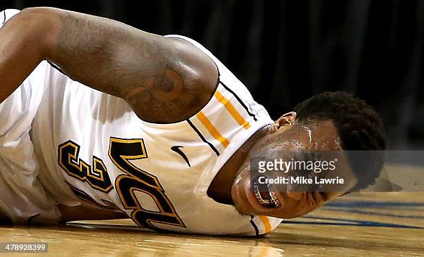 Melvin Johnson of the Virginia Commonwealth Rams lies on the court after an injury in the first half against the George Washington Colonials during...