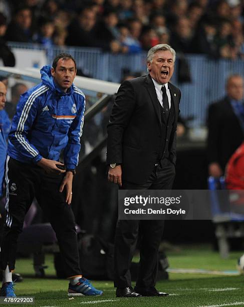 Head coach Carlo Ancelotti of Real Madrid FC urges on his team beside his assistant coach Paul Clement during the La Liga match between Malaga and...