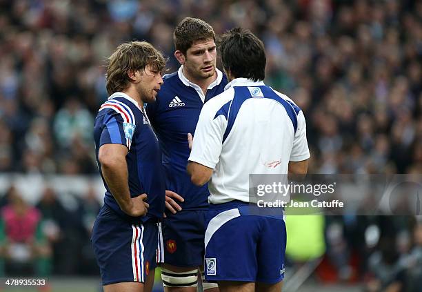 Referee Steve Walsh of Australia talks to Dimitri Szarzewski and Pascal Pape of France during the RBS Six Nations match between France and Ireland at...