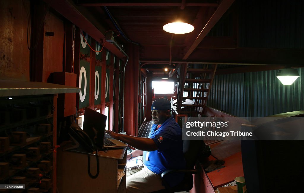 Center-field scoreboard operator enjoys job from best seat in the house