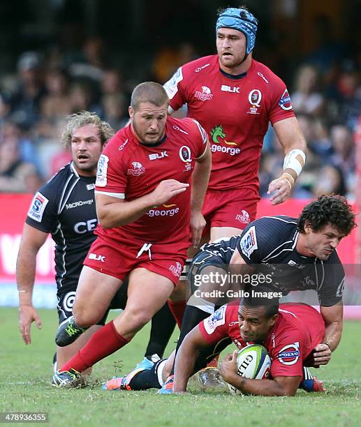 Ryan Kankowski of the Cell C Sharks tackles Will Genia of the Reds during the Super Rugby match between Cell C Sharks and Reds at Growthpoint Kings...