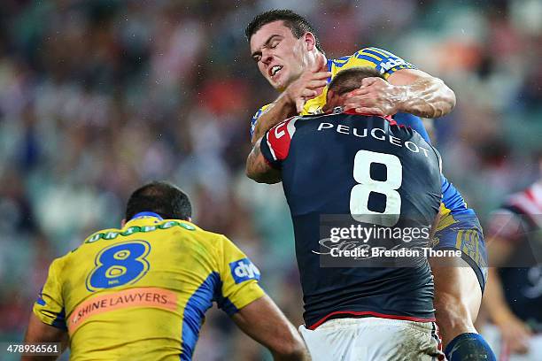 Jared Waerea-Hargreaves of the Roosters receives a high shot from Darcy Lussick of the Eels during the round two NRL match between the Sydney...