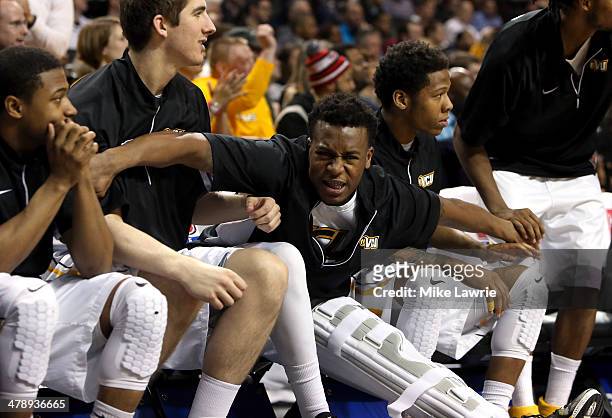 Melvin Johnson of the Virginia Commonwealth Rams celebrates in a knee brace with teammates in the second half after sustaining an injury in the first...