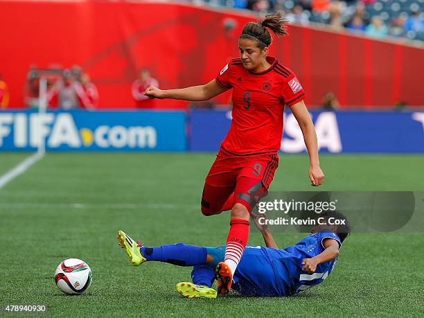 Anootsara Maijarern of Thailand challenges Lena Lotzen of Germany during the FIFA Women's World Cup Canada 2015 match between Thailand and Germany at...