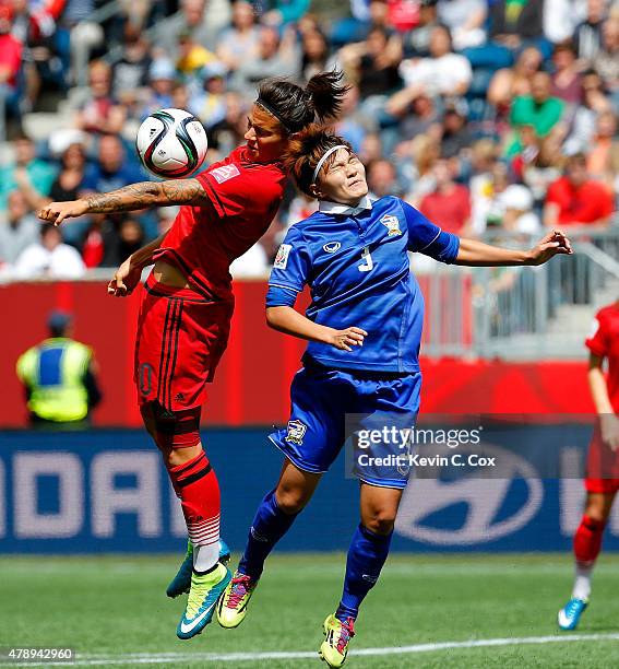 Natthakarn Chinwong of Thailand challenges Dzsenifer Marozsan of Germany during the FIFA Women's World Cup Canada 2015 match between Thailand and...