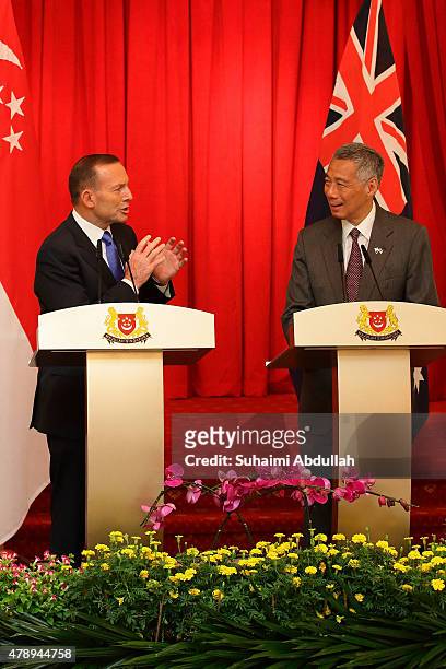Australian Prime Minister Tony Abbott speaks during the joint press conference as Singapore Prime Minister Lee Hsien Loong looks on at the Istana on...