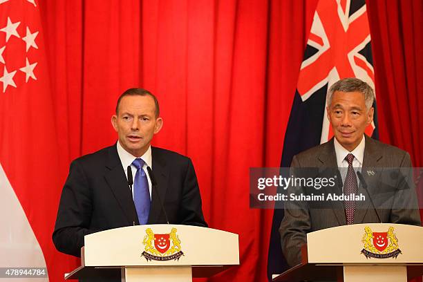 Australian Prime Minister Tony Abbott speaks during the joint press conference as Singapore Prime Minister Lee Hsien Loong looks on at the Istana on...