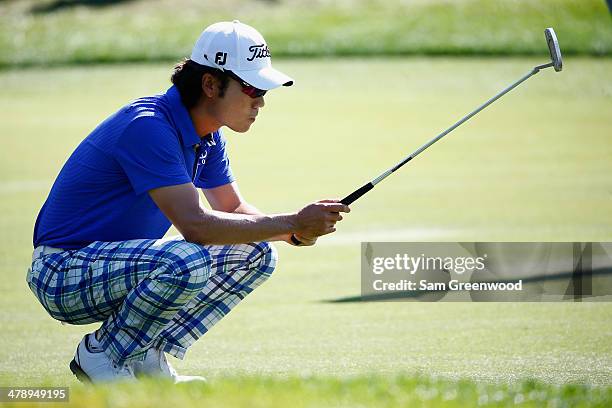 Kevin Na of South Korea assesses a putt on the 8th green during the third round of the Valspar Championship at Innisbrook Resort and Golf Club on...
