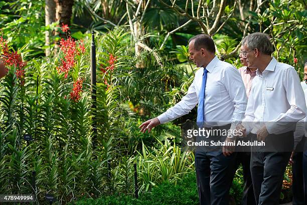 Australian Prime Minister Tony Abbott tours the orchid garden accompanied by Ntional Parks Deputy Director Dr David Middleton at the National Orchid...