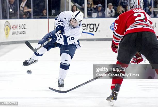Penn State's Eric Scheid passes the puck past Ohio State's Justin DaSilva on Saturday, March 15 at Pegula Ice Arena in State College, Pa. The Nittany...