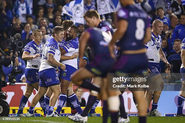 The Bulldogs celebrate a try during the round 16 NRL match between the Canterbury Bulldogs and the Melbourne Storm at Belmore Sports Ground on June...