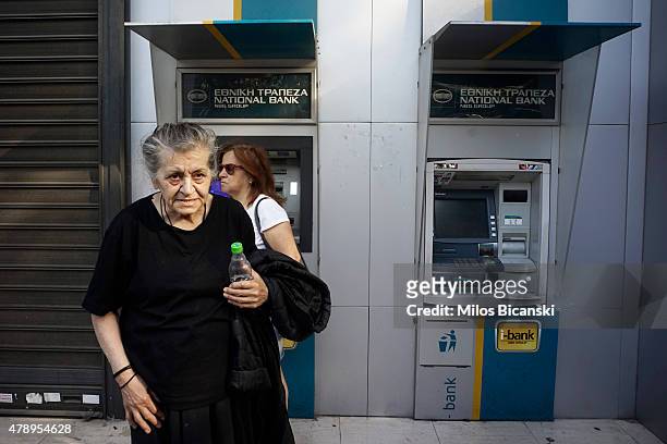 Pensioner visits a branch of the National Bank of Greece hoping to draw her pension on June 29, 2015 in Athens, Greece. Greece closed its banks and...