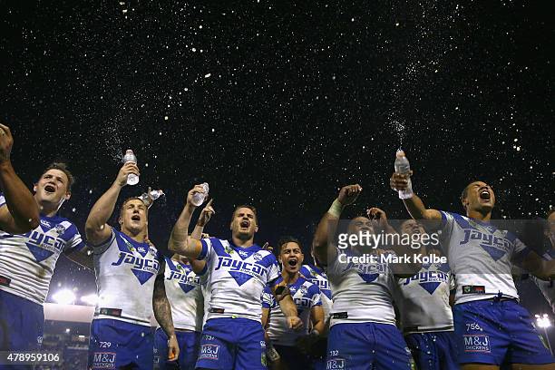 The Bulldogs team sing their team song in front of the crowd on the hill as they celebrate victory during the round 16 NRL match between the...