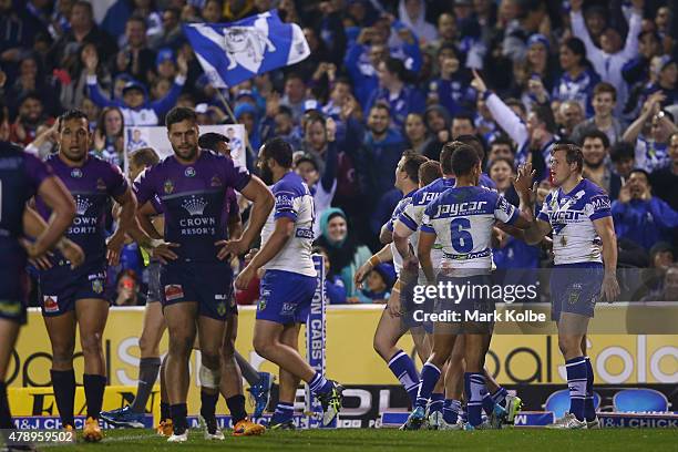 The Bulldogs celebrate after a try scored by Josh Morris of the Bulldogs during the round 16 NRL match between the Canterbury Bulldogs and the...