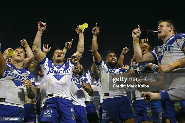 The Bulldogs team sing their team song in front of the crowd on the hill as they celebrate victory during the round 16 NRL match between the...