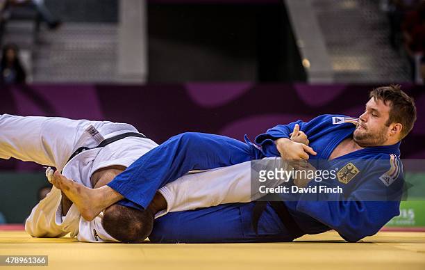 Andre Breitbarth of Germany attempts to armlock Michal Horak of the Czech Republic in their team contest before converting to a unique hold. Germany...