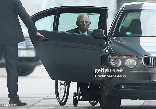 German Finance Minister Wolfgang Schaeuble arrives at the Chancellery for an extraordinary meeting with German Chancellor Angela Merkel and the...