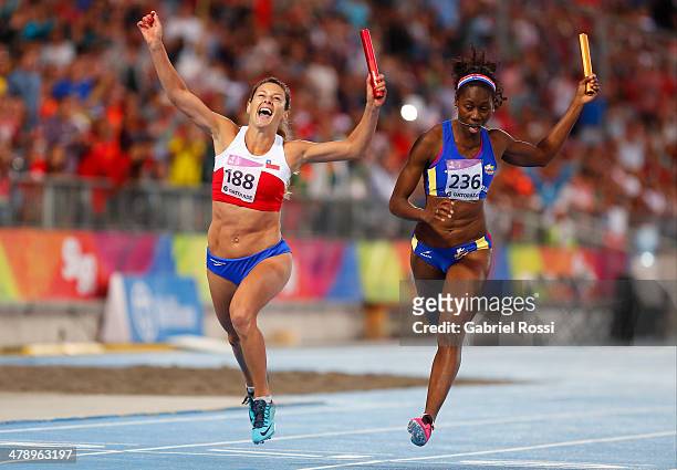Daniela Riderelli of Chile crosses the finish line in the second position, followed by Eliecit Palacios of Colombia in the Women's 4x100 relay event...