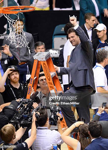 Head coach Steve Alford of the UCLA Bruins cuts down a net after defeating the Arizona Wildcats 75-71 in the championship game of the Pac-12...