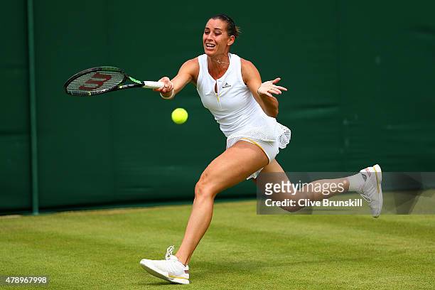 Flavia Pennetta of Italy plays a forehand in her Ladiess Singles first round match against Zarina Diyas of Kazakhstan during day one of the...