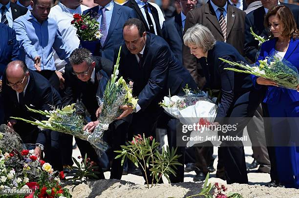 German Interior Minister Thomas de Maiziere , Tunisia's Interior Minister Mohamed Gharsalli , British Home Secretary Theresa May lays flowers at the...