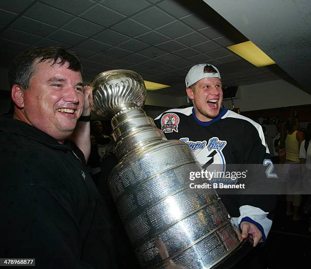 Stan Neckar of the Tampa Bay Lightning celebrates in the locker room with the Stanley Cup after defeating the Calgary Flames in Game 7 of the NHL...