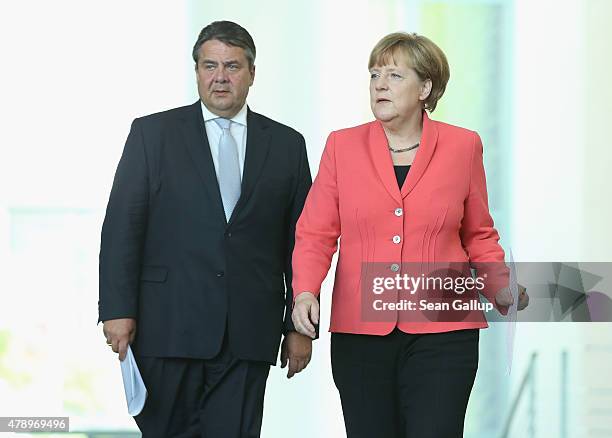 German Chancellor Angela Merkel and Vice Chancellor and Economy and Energy Minister Sigmar Gabriel arrive to speak to the media following an...