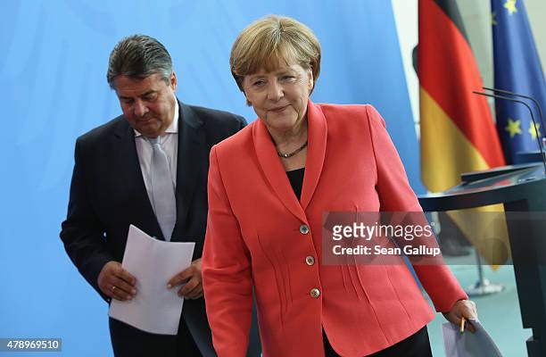 German Chancellor Angela Merkel and Vice Chancellor and Economy and Energy Minister Sigmar Gabriel depart after they spoke to the media following an...