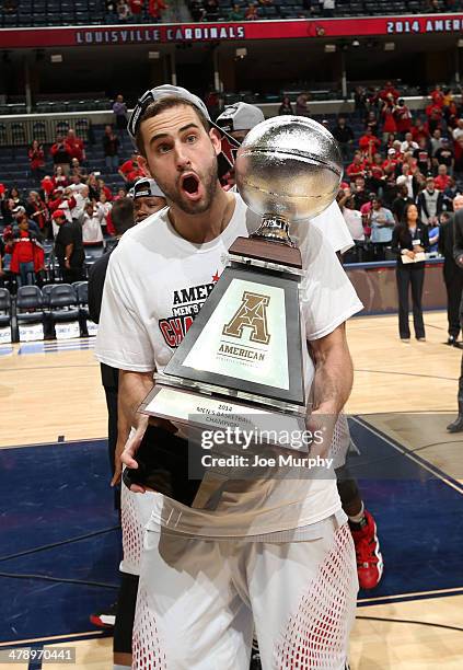 Luke Hancock of the Louisville Cardinals celebrates with the championship trophy after defeating the Connecticut Huskies during the Championship of...