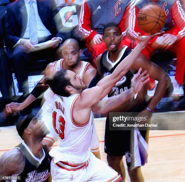 Joakim Noah of the Chicago Bulls puts up a shot past DeMarcus Cousins of the Sacramento Kings as Taj Gibson and Jason Thompson watch the action at...