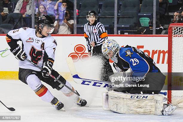 Kenton Helgesen of the Calgary Hitmen takes a shot on Mackenzie Skapski of the Kootenay Ice during a WHL game at Scotiabank Saddledome on March 15,...