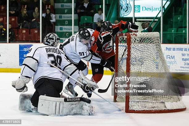 Jean-Sebastien Dea of the Rouyn-Noranda Huskies scores his third period goal against Alexandre Alain and Anthony Brodeur of the Gatineau Olympiques...