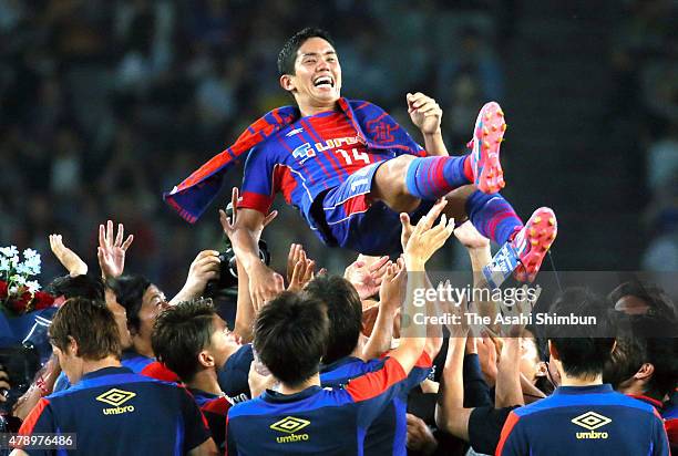 Yoshinori Muto of FC Tokyo is thrown into the air during his sending off ceremony after the J.League match between FC Tokyo and Shimizu S-Pulse at...